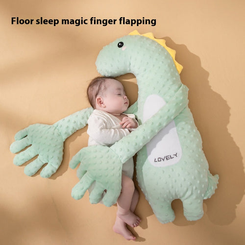 Baby sleeping hugged by a mint green dinosaur soothing pillow with arms