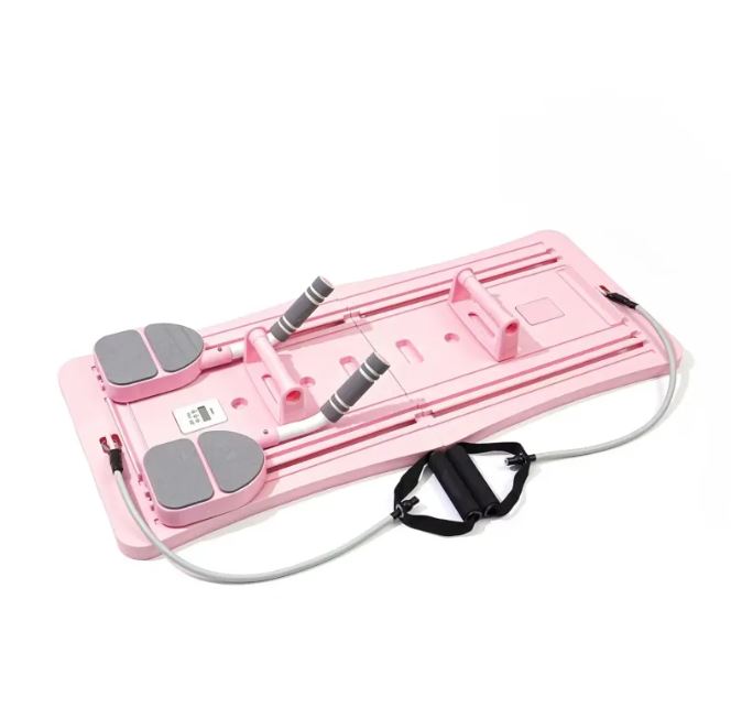 Pink Pilates sliding board with foot pads and resistance bands shown upright