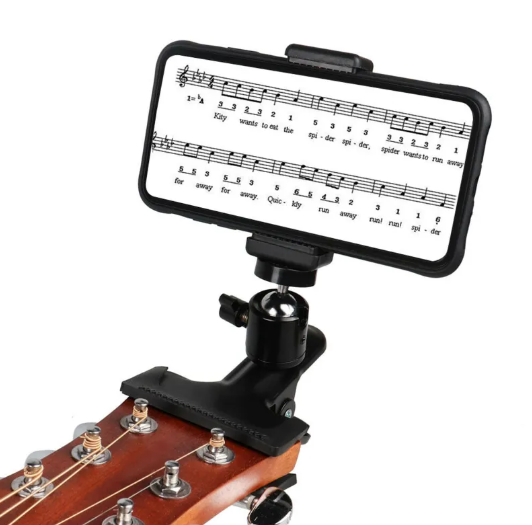 Phone guitar clip stand holding sheet music on a guitar headstock