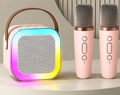 Pink Bluetooth karaoke speaker with RGB light ring and two microphones shown upright