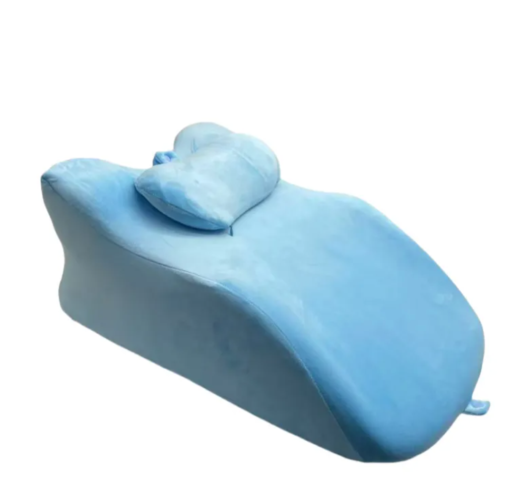 Light blue stomach sleeper pillow with removable headrest, front view
