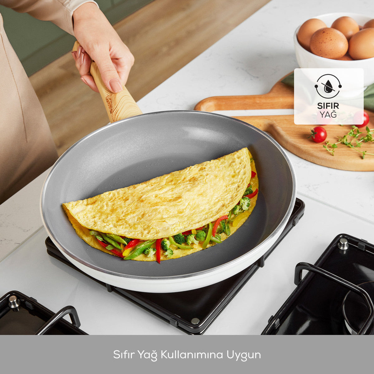 Omelet cooking in a nonstick frying pan on a gas stove