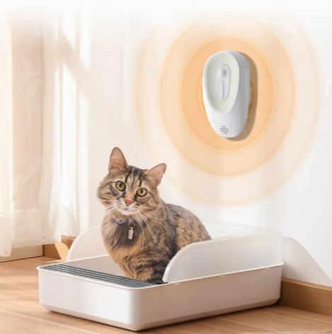 Cat in a litter box below a pet odor eliminator
