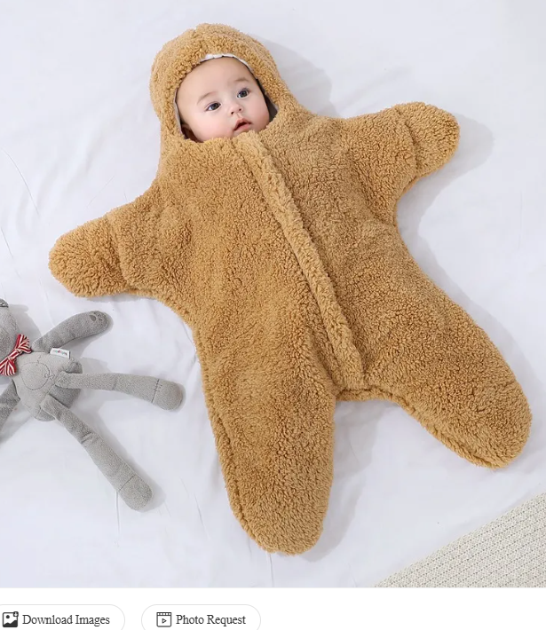 Baby in a tan hooded fleece starfish-shaped baby quilt sleep sack on a white background