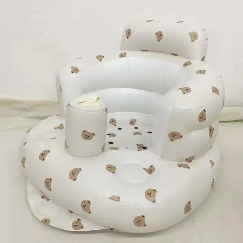 Bear print inflatable baby chair in a sunny room by a wicker basket on a white background