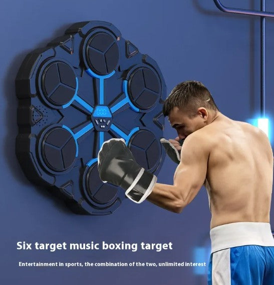 Man in boxing gloves punching a wall-mounted music boxing target machine