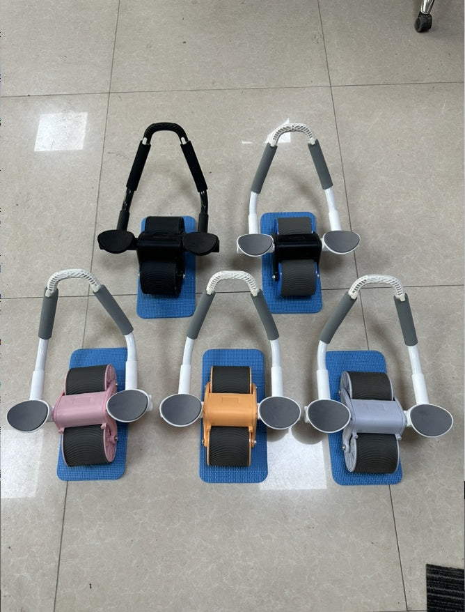 Automatic rebound abdominal wheels in several colors on a tile floor