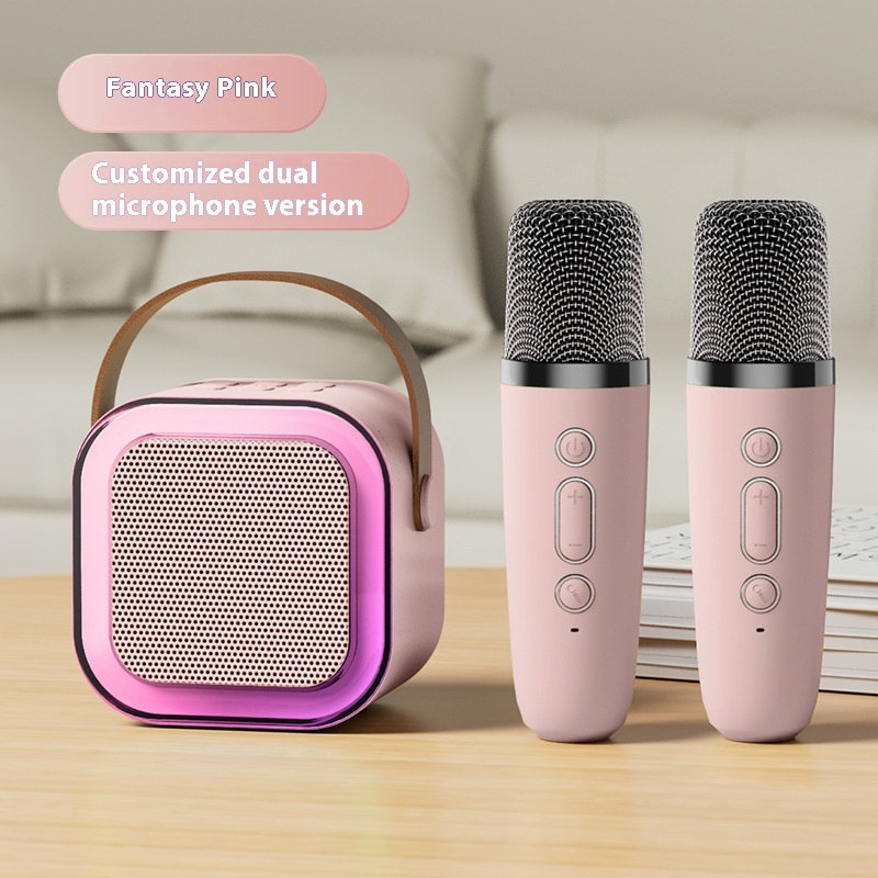 Pink Bluetooth karaoke speaker with RGB light ring and two microphones, front view