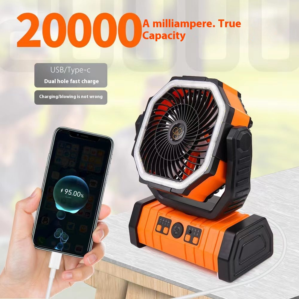 Hand charging a phone from an orange 20000mAh camping fan power bank