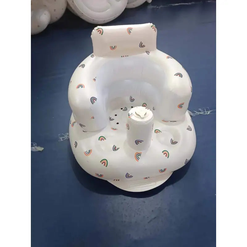 White inflatable baby chair with bear print and front cup holder shown upright