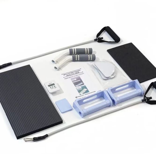Pilates board accessories laid out: mat, bands, handles and sliders
