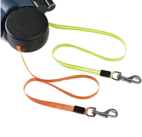 Dual retractable dog leash with lime and orange leads unspooled