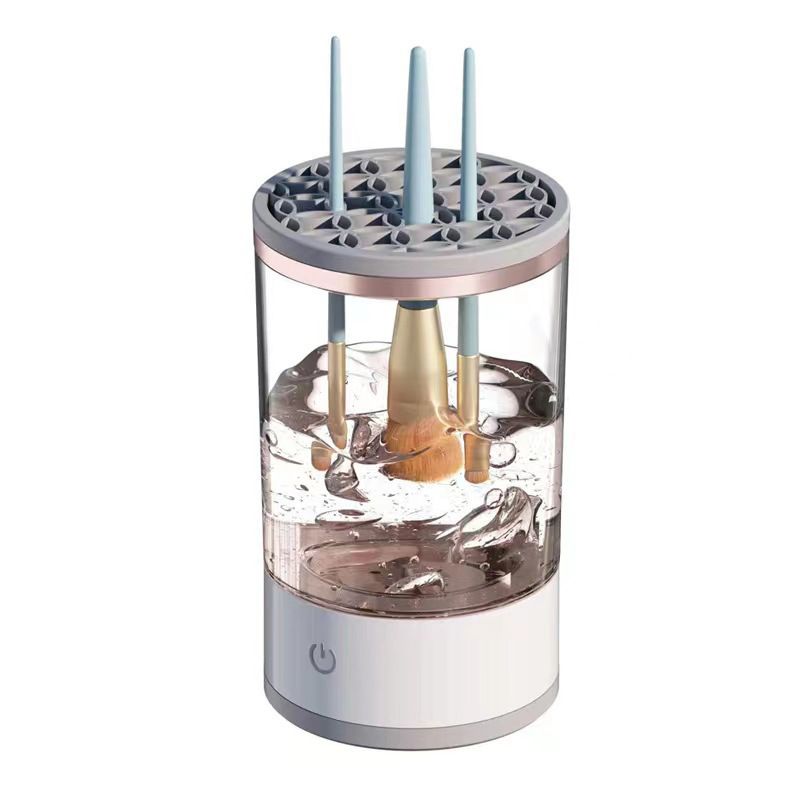 Electric makeup brush cleaner spinning brushes in soapy water