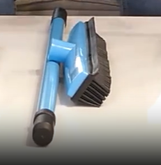 Close-up of a blue rubber pet hair broom's squeegee and bristles