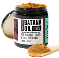 Jar of 100% batana oil hair mask with a wooden scoop